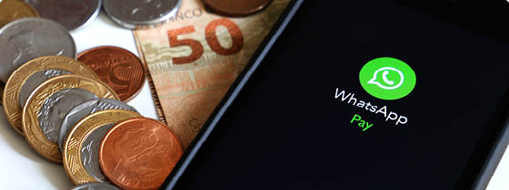 SÃƒO PAULO, BRAZIL - 05, 2021: Central bank of Brazil authorizes money transfer by WhatsApp  Mobile phone screen with WhatsApp application logo and Brazilian Reais on white background