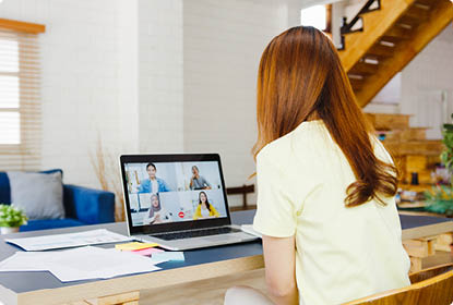 Asia businesswoman using laptop talk to colleagues about plan in video call meeting while working from home at living room  Self-isolation, social distancing, quarantine for corona virus prevention 