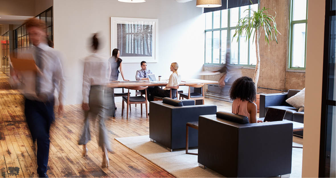 Business people at work in a busy luxury office space