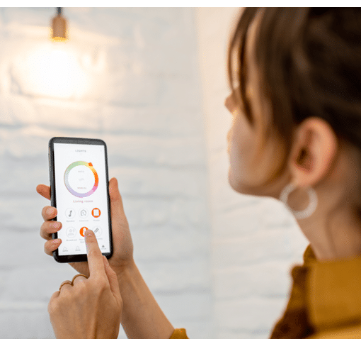 Controlling light bulb temperature and intensity with a smartphone application  Concept of a smart home and managing light with mobile devices