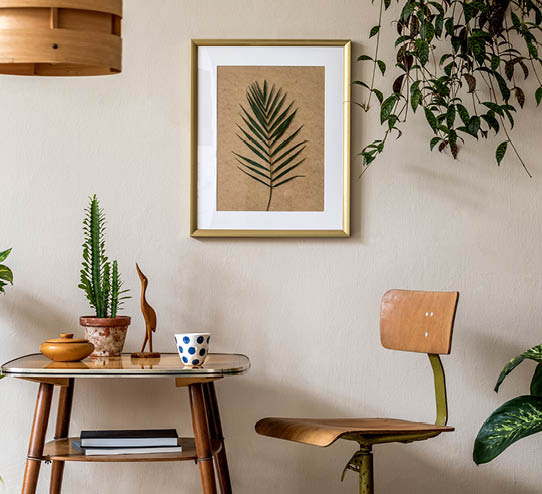 Retro interior design of living room with stylish vintage chair and table, plants, cacti, personal accessories and gold mock up poster frame on the beige wall  Elegant home decor  Template  
