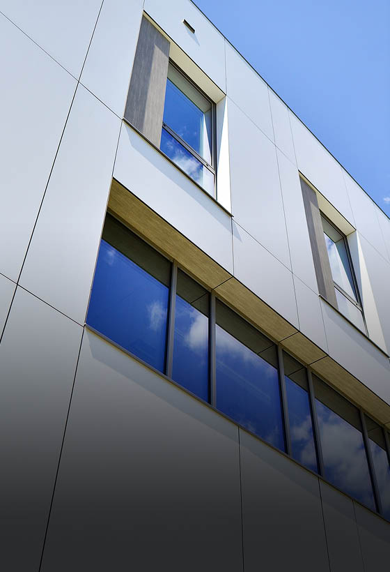 Office building with white aluminum composite panels  Facade wall made of glass and metal  Abstract modern business architecture 