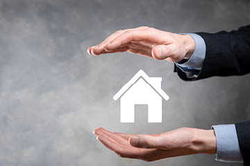 Real estate concept, businessman holding a house icon House on Hand Property insurance and security concept  Protecting gesture of man and symbol of house 